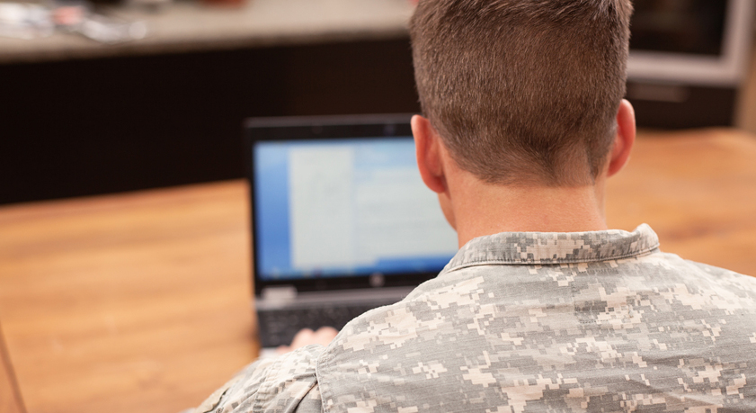 Military person on computer